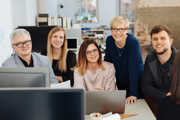 Happy successful business team posing in an office