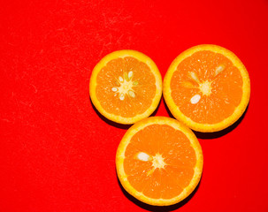 Oranges isolated on red background
