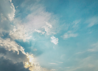 Dark Grey Cloud Cover the Sun. Sun light Bursting Behind the Cloud. Blue Pastel Color Sky.