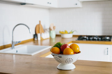 Wet fresh vegetables in white colander