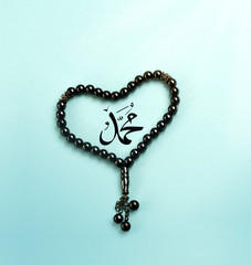 Islamic Beads With Heart Shape Use in Friday Prayer To Allah. Muslim Tasbeeh. Love Prophet Muhammad Concept. Arabic Text Translation : Muhammad.