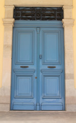 Wooden front door in marble doorway