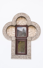 old stone carved window in club shape