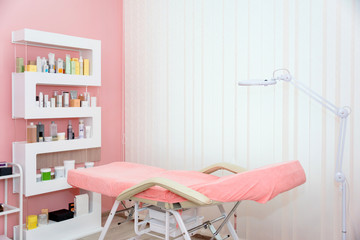 Cosmetologist cabinet with massage table in modern beauty saloon. Medical cabinet interior.