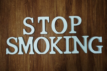Stop Smoking word alphabet letters on wooden background