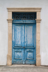 wooden vintage front door with a metal lattice