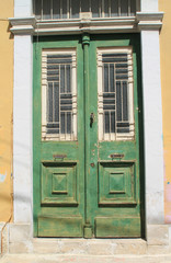 Old wooden front door with metall grills