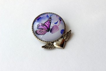 metal brooch with butterfly on white background