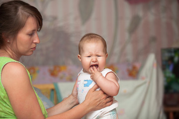 a young woman with a child is teething