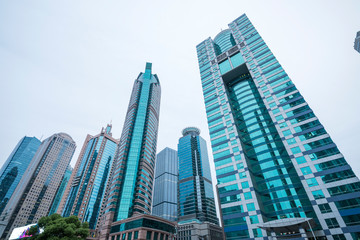 Fototapeta premium A cluster of tall buildings in the leaves