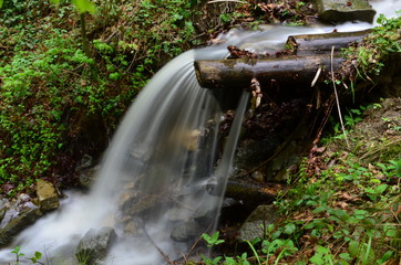 beautiful waterfall with clear water on a mountain stream in the forest