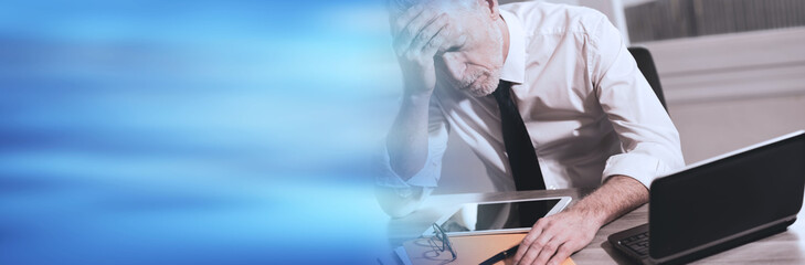 Stressed businessman sitting in office. panoramic banner