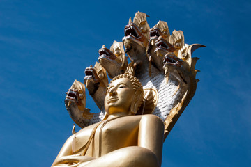 Tha Ton Thailand, close-up of giant buddha seated under seven headed naga at Wat Tha Ton
