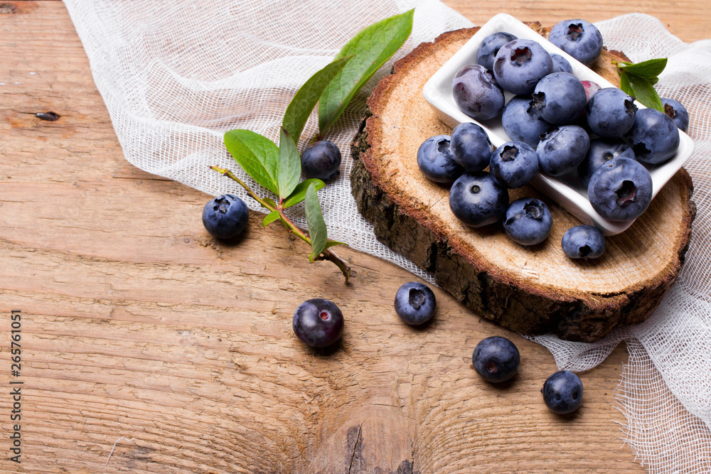 Wall mural Fresh organic berries on a wooden background.