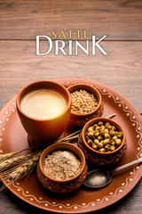 Sattu sharbat is a cooling sweet drink made in summer with roasted black chickpea flour, barley, suger, salt & water. served in a glass. selective focus