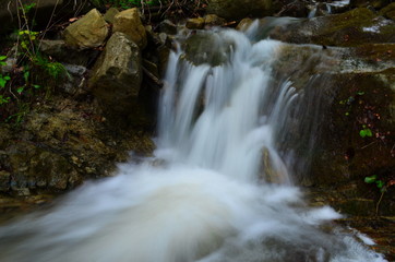 beautiful waterfall with clear water on a mountain stream in the forest
