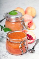 Homemade peach jam with organic fruit. Sweet preserves on a light background
