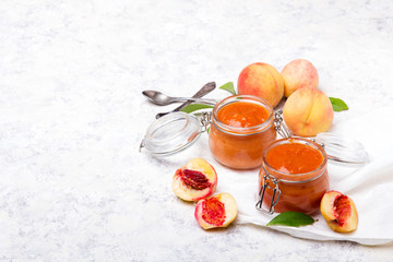 Homemade peach jam with organic fruit. Sweet preserves on a light background, , copy space
