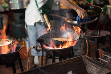 Fire burn is cooking on iron pan.