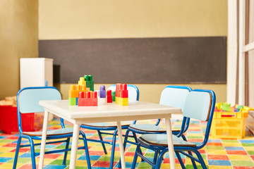 Bauklötze auf einem Tisch im Kindergarten - obrazy, fototapety, plakaty