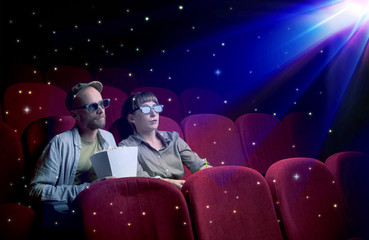 Naklejka premium Lovely couple watching 3D movie with little sparkling stars around
