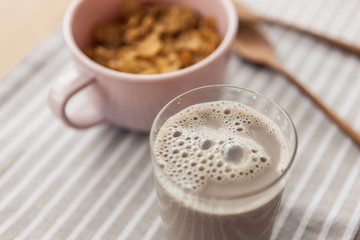 cereal with soy milk on the fabric mat, wood table for breakfast.