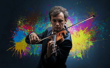 Fototapeta premium Young classical violinist musician with colorful splotch wallpaper 