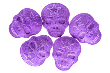 Purple MDMA, Amphetamine, Army Skull, Ecstasy, XTC pills isolated on a white background.
