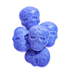 Blue MDMA, Amphetamine, Army Skull, Ecstasy, XTC pills isolated on a white background.