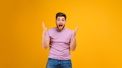 Young handsome man with copyspace isolated over yellow background