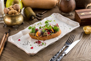 Italian Appetizer Bruschetta with tomatoes, radish, mushroom and greens on wooden table