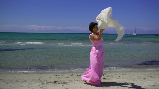 Slow motion. a sea adventure of an adult wealthy woman walking on a beautiful tropical beach