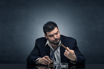 Young drunk man at his office with free dark copyspace