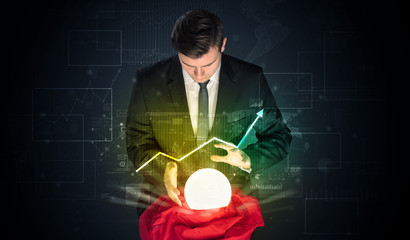 Young businessman making predictions of the future of the stock market with a magic ball
