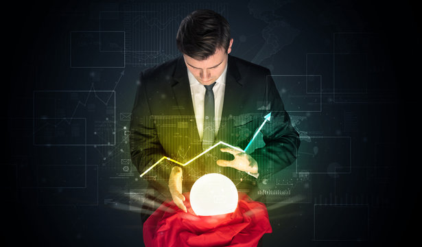 Young businessman making predictions of the future of the stock market with a magic ball
