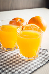 Photo of fresh orange juice in the glass jar. Summer healthy organic drink concept. Cold beverages with ice and orange fruits.