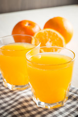 Photo of fresh orange juice in the glass jar. Summer healthy organic drink concept. Cold beverages with ice and orange fruits.