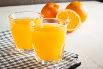 Photo of fresh orange juice in the glass jar. Summer healthy organic drink concept. Cold beverages with ice and orange fruits.
