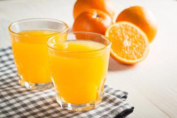 Photo of fresh orange juice in the glass jar. Summer healthy organic drink concept. Cold beverages with ice and orange fruits.