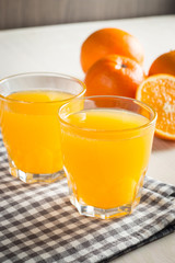 Photo of fresh orange juice in the glass jar. Summer healthy organic drink concept. Cold beverages with ice and orange fruits.