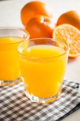 Photo of fresh orange juice in the glass jar. Summer healthy organic drink concept. Cold beverages with ice and orange fruits.