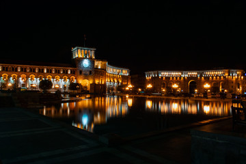 Fototapeta premium Yerevan, Armenia - 18 APR 2019: Yerevan city center, Republic square with fountain and parliament building in the background. Night photography - Image