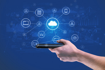 Businessman working on phone with reports and graphs concept around
