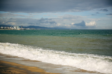 Beautiful beach on sunny day. Waves on the sea. Holiday travel concept. Barcelona Spain views.