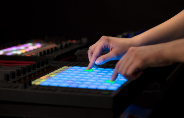 Fototapeta premium Dj hand remixing music on midi controller 