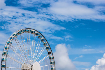 City under the blue sky white cloud ferris wheel