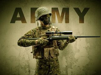 Uniformed armed soldier with damaged wall background
