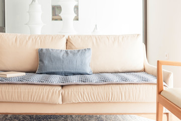 iviry sofa with blanket, cushion at the living room.