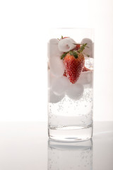 Strawberries in sparkling water with ice