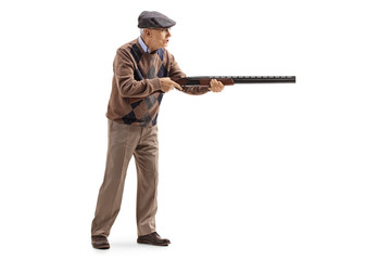 Elderly man aiming with a shotgun